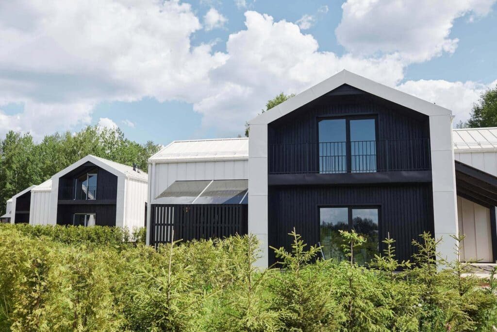 Evergreen Mountain Modern: Modern black-and-white gabled homes set in a green meadow in Crestmoor, Denver, CO