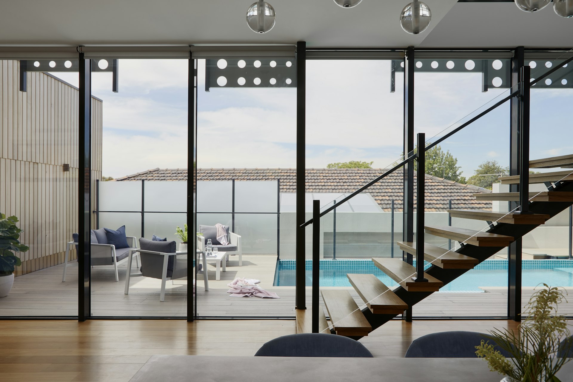 Open-plan living room opening onto a pool terrace